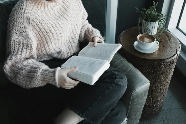 Mulher lendo livro leituras para intercâmbio